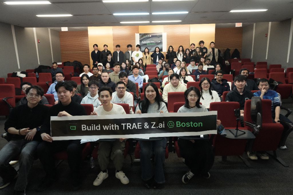 A full auditorium of GaGro members holding the Build with TRAE & Z.ai Boston banner